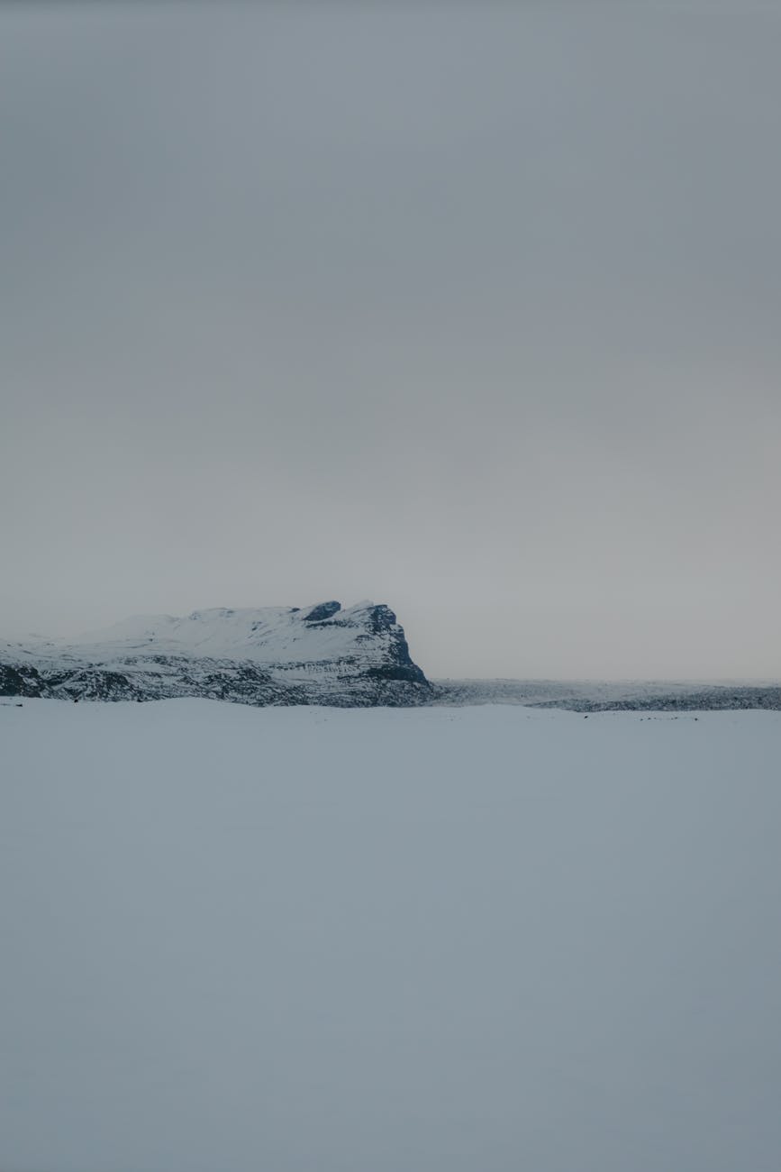 serene snowy landscape with mountain cliff